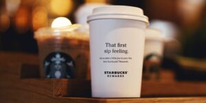 Picture of a Starbukcs cup with a message that says "that first sip feeling. Let us add a little joy to your day. Join Starbucks rewards."
