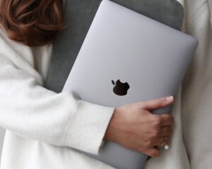 woman holding an apple laptop